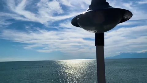 The sun flickers over the waves on a calm afternoon with a lantern in the Video stock 264054945