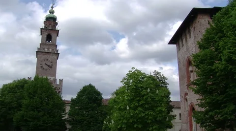 Sun flooding light on trees and Bramante tower, Vigevano, PV, Italy Stock-Footage 62479913