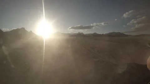 Sun glare and dust behind Egyptian desert shaky and bumpy Jeep trip 50fps Video stock 231308573