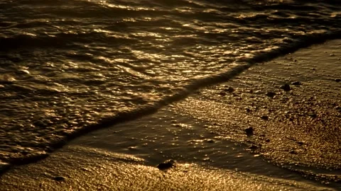 Sun glare on the golden wave in the surf zone on a sandy beach. Stock Footage 142932452