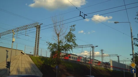 Sun glare on a modern train , moving on the steel overpass Stock Footage 76449301