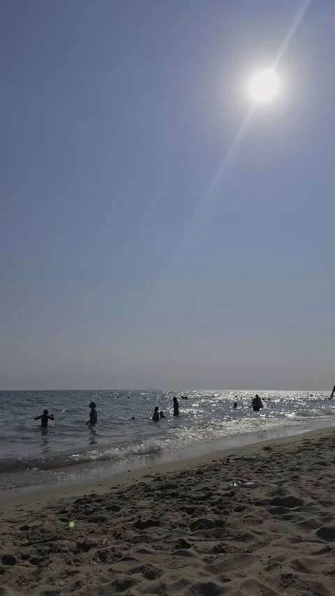 Sun Glare Over Swimmers Wading in the Sea at Chalkidiki Beach Video stock 345021765