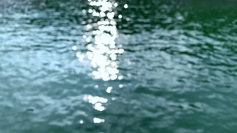 Sun glare reflected in water surface. rays flickering in water stream. Stock Footage 118007094