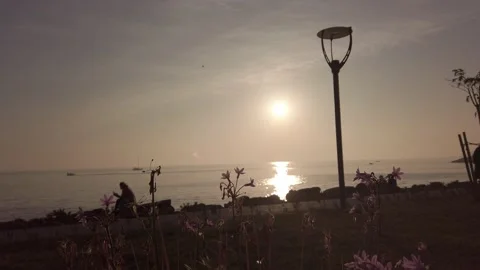 Sun glare, sunny path, small waves with white foam. Amazing sunset. Dramatic sky Stock Footage 143853377