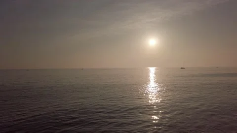 Sun glare, sunny path, small waves with white foam. Amazing sunset. Dramatic sky Stock Footage 143853379