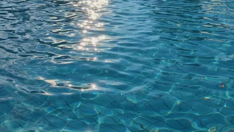 Sun glare on the water of the pool - water abstract background. Surface of blue Stock Footage 250434404