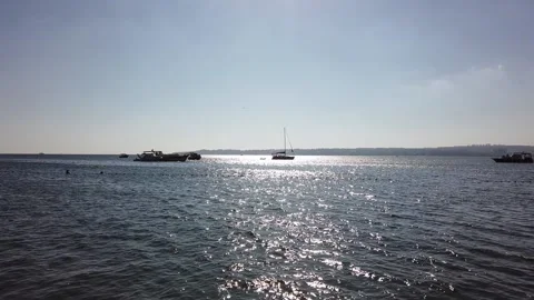 Sun glare on water surface. Clear blue sky. Private yachts, boats, ships. Stock Footage 138530613