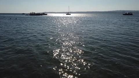 Sun glare on water surface. Clear blue sky. Private yachts, boats, ships. Stock Footage 138530617