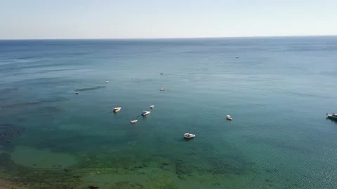 Sun glare on water. Top view. Pure clear sea water in bay. Small boats, yachts. Stock Footage 139441571