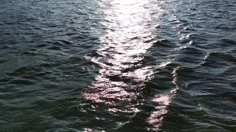 Sun glare on the waves of the water surface Stock Footage 252385612