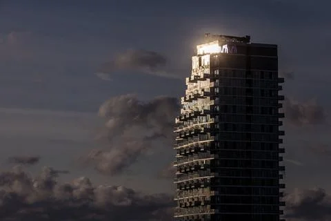 Sun glinting off top of condo tower Stock Photos