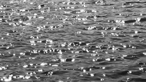 Sun glints on ocean waves in dramatic noir style. Stock Footage 337304937