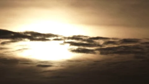 Sun Glowing Behind Dark Clouds Time Lapse Stock Footage 84770032