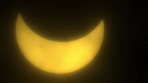 Sun Glowing Yellow Behind Passing Clouds During Partial Eclipse Stock Footage 273012231