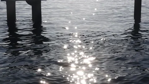 Sun glows in the sea slow motion Stock Footage 147947664