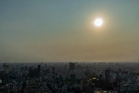 Sun glows softly over hazy urban skyline Stock Photos