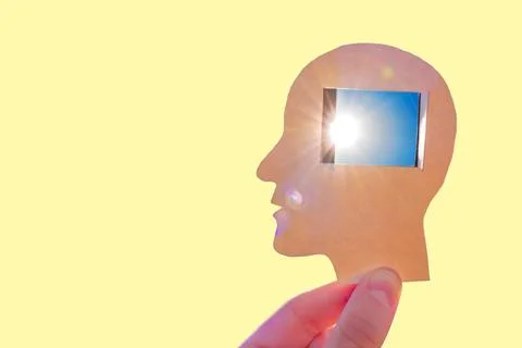 Sun Glows Through Window Shaped Opening in Brain Area of Paper Head Silhouett Photos