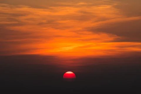 Sun is go down during sunset time and orange clouds Stock Photos