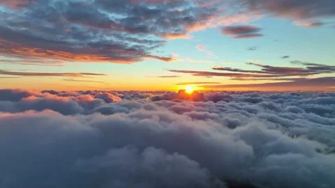 Sun goes into the clouds. Epic sunset in the sky, aerial shot. Flying above the Video stock 237879860
