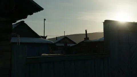 Sun goes down over the house rooftops of Siberian village, Russia Stock-Footage 233261942