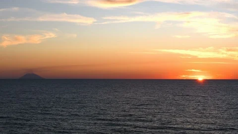 Sun goes down on the sea with view on the vulcan Stock Footage 113054048