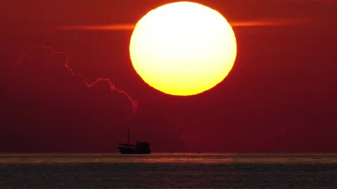 Sun goes down with ship driving in foreground. telephoto lens real shot. part 2 Stock Footage 218632128