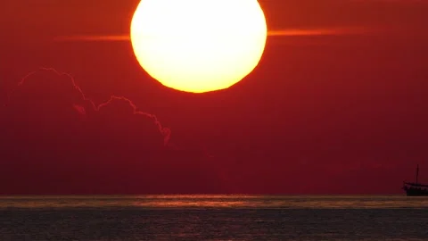 Sun goes down with ship driving in foreground. telephoto lens real shot. part 1 Stock Footage 218632321