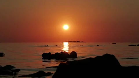 Sun Goes Down At Sunset In The Sea. Birds Fly Past An Ocean Island Stock Footage 168174062
