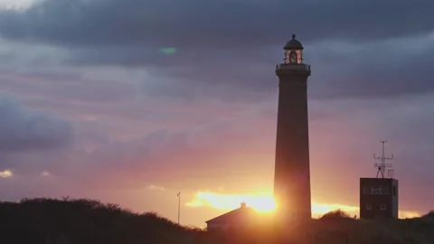 Sun going down behind a lighthouse Stock Footage 231128706