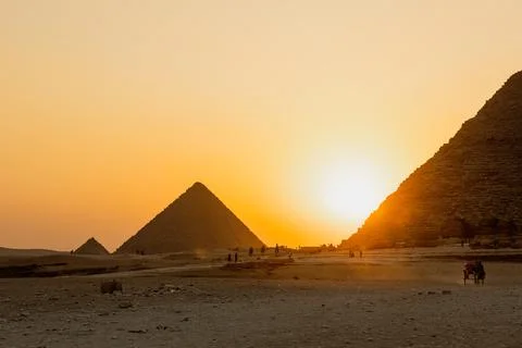 The sun is going down behind the pyramid of Giza, Egypt Stock Photos