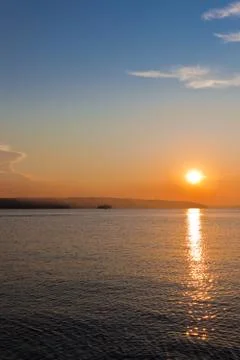 Sun going down on a horizon Stock Photos