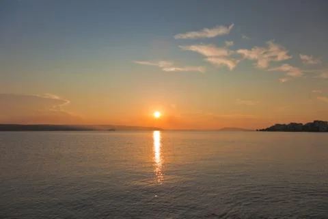 Sun going down on a horizon Stock Photos
