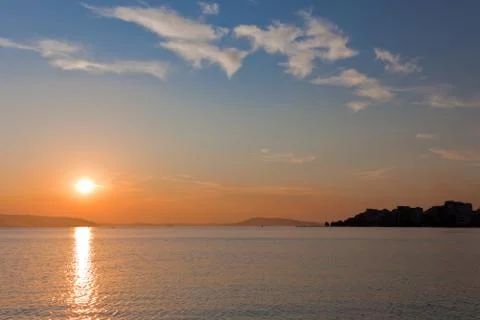 Sun going down on a horizon Stock Photos