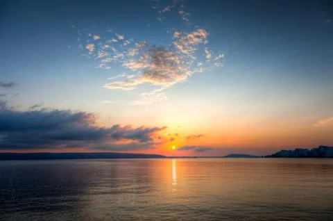 Sun going down on a horizon Stock Photos