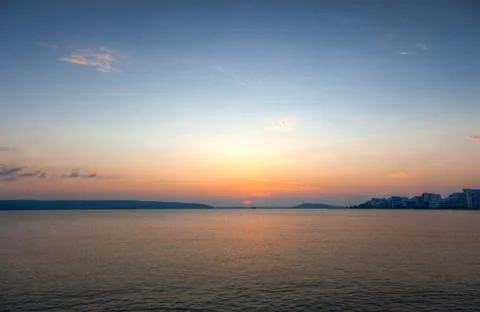 Sun going down on a horizon Stock Photos