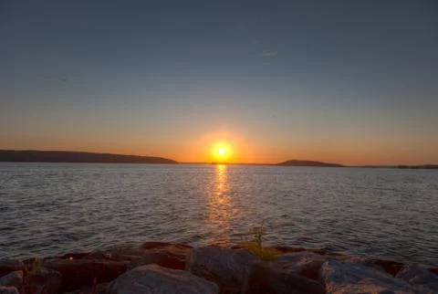 Sun going down on a horizon Stock Photos