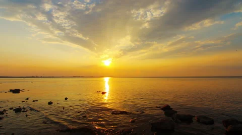 The sun is going down into the sea. Blue and orange sky make perfect view. Stock Footage 53519381