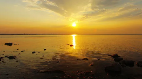 Sun going down into the sea makes bright water Stock Footage 53616549