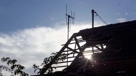 Sun going down through abandoned house roof Stock Footage 43360747