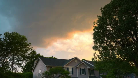 Sun in golden purple clouds on the sunset sky above summer landscape in the Stock-Footage 314975949