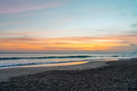 The sun gracefully dips below the horizon, casting warm hues across the tra.. Stock Photos