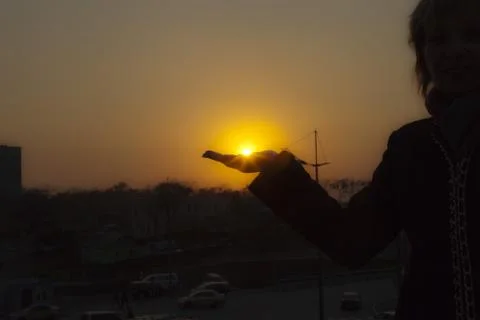 The sun in a hand Stock Photos