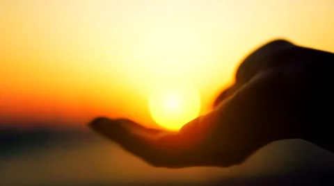 Sun in hands. Hand taking a sun against beautiful sea sunset on horizon. Nature. Stock Footage