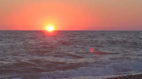 Sun hanging low over imaginary horizon of the sea edge Stock Footage 8365971