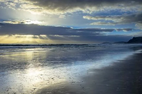 Sun Harp Through Clouds during Sunset over Hauraki Coast Stock Photos