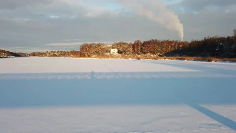 The sun has just risen and lights up a frozen lake Stock Footage 148932623