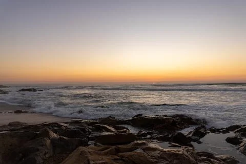 The sun has set, and twilight begins along the shores  Stock Photos