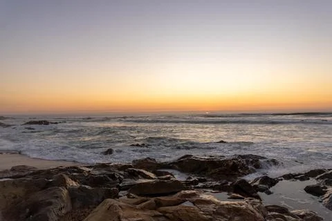 The sun has set, and twilight begins along the shores  Stock Photos