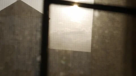 Sun heat Through Dusty Window Screen with Rooftop Silhouette Stock Footage 340305156