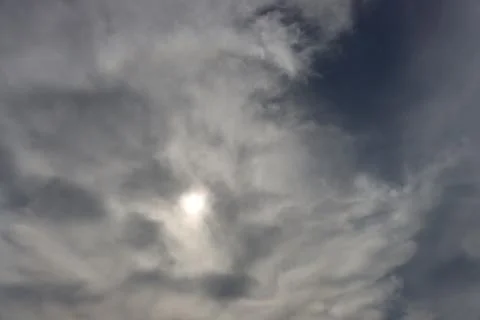 The sun is hidden behind thick clouds. Stock Photos